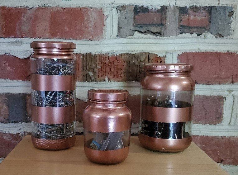 Glass jars painted filled with office supplies
