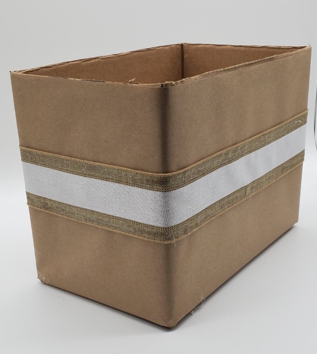 DIY cardboard box covered in kraft paper and ribbon